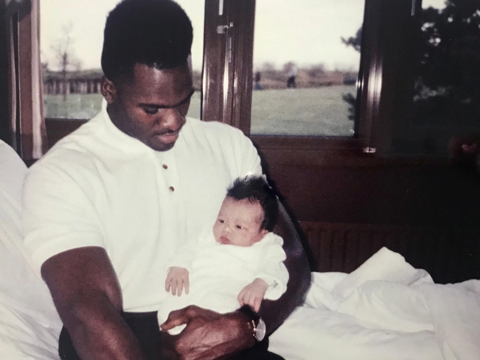 Lamar Lowery als junger Mann mit einem Baby im Arm